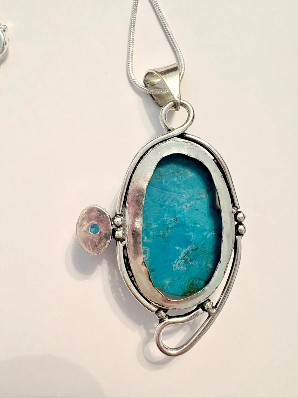 2 1/2 inch, 925 marked, Turquoise and Blue Topaz pendant on a silver chain.